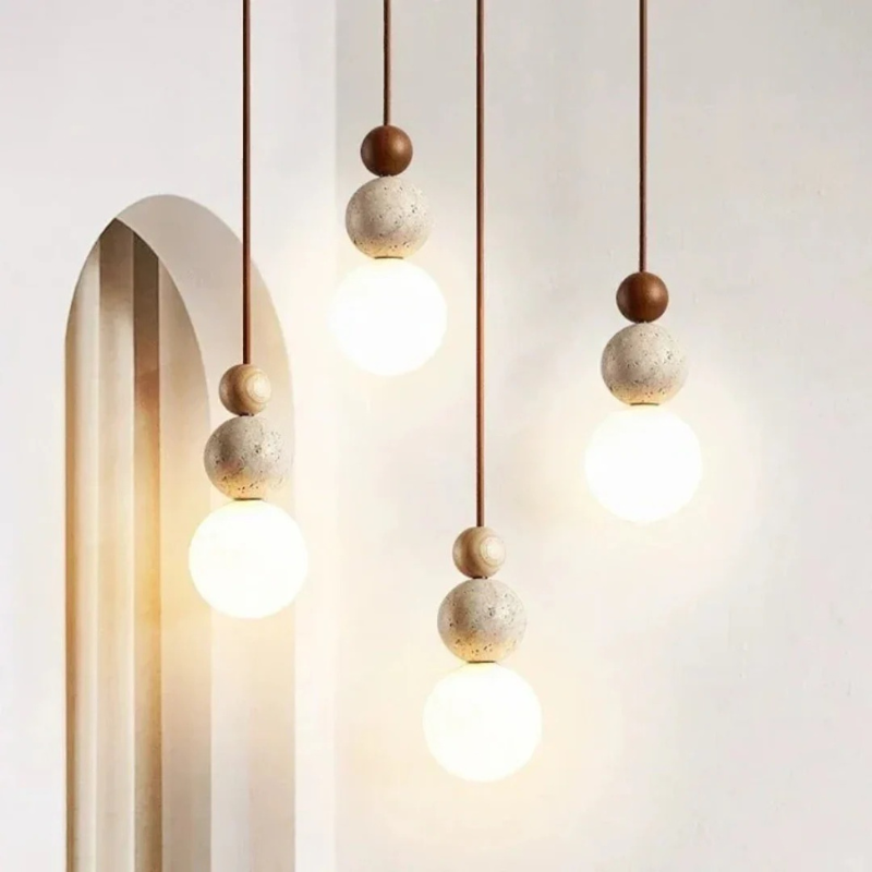 Moderne Pendelleuchte aus Travertin und Mahagoni mit warmem Licht, an einer Schnur aufgehängt, geeignet für Wohn- oder Essbereiche.